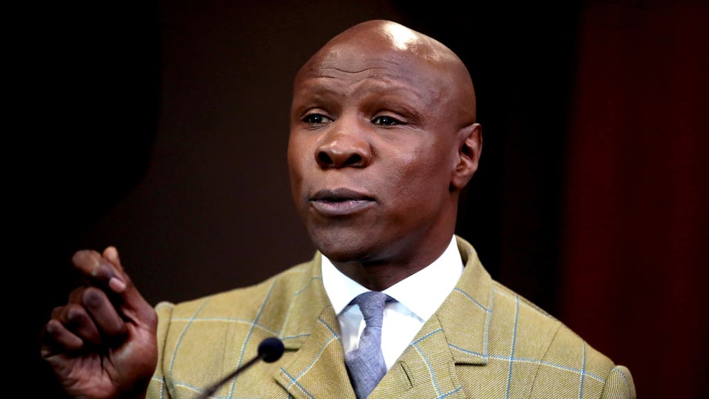 Chris Eubank Sr mid-speech, hand raised, declaring with intensity